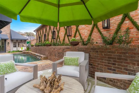 a backyard of a house with barbeque oven and outdoor seating