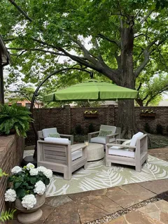 a view of a backyard with sitting area