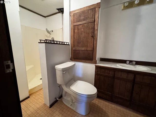 a white toilet sitting next to a sink