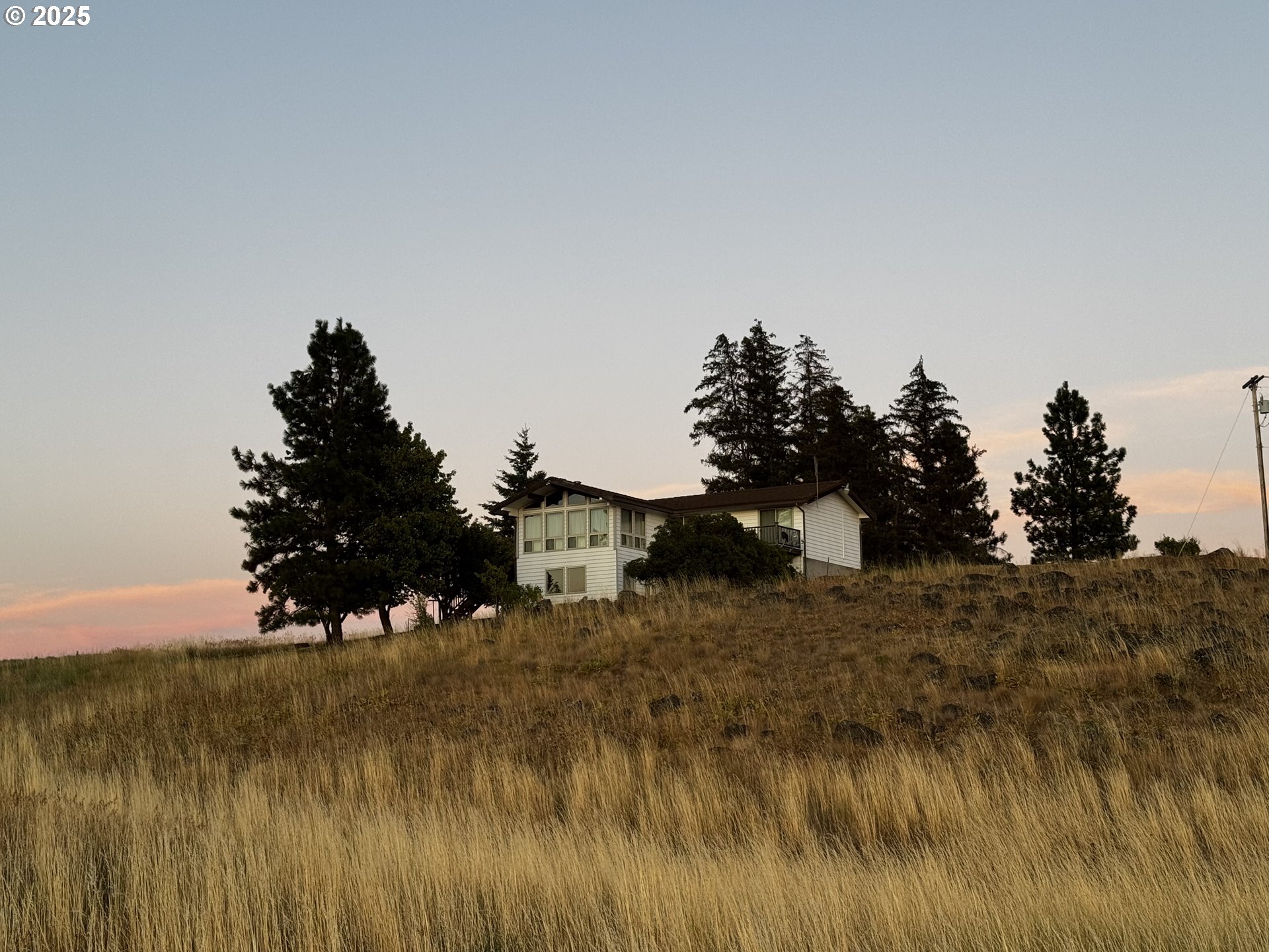 44 North Harris Road Goldendale, WA 98620 - Photo 6 of 36 a view of a lake with trees in the background