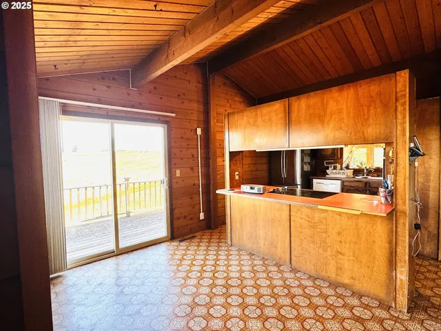 a large kitchen with a large window and a sink
