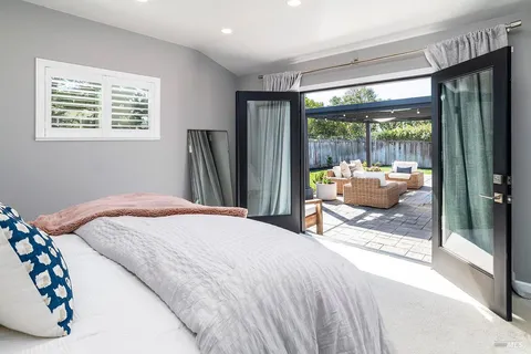 a bedroom with a bed and a large window