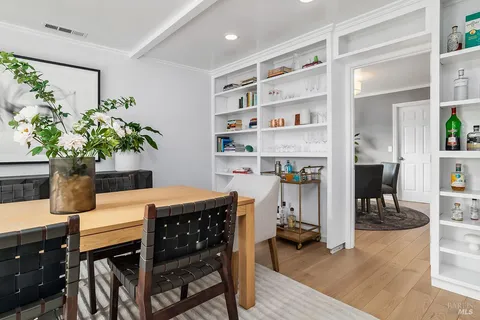 a dining room with furniture and a potted plant