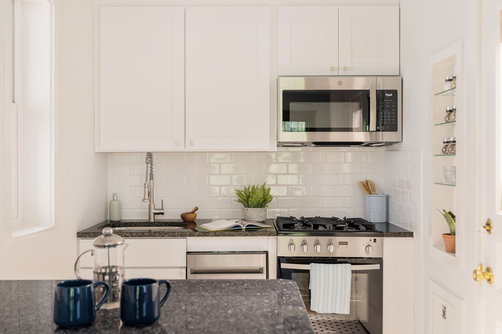2 Clinton Street, Unit 37 Cambridge, MA 02139 - Photo 12 of 23 a kitchen with a stove and a microwave
