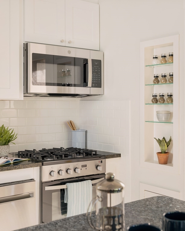 2 Clinton Street, Unit 37 Cambridge, MA 02139 - Photo 13 of 23 a kitchen with a stove and a microwave