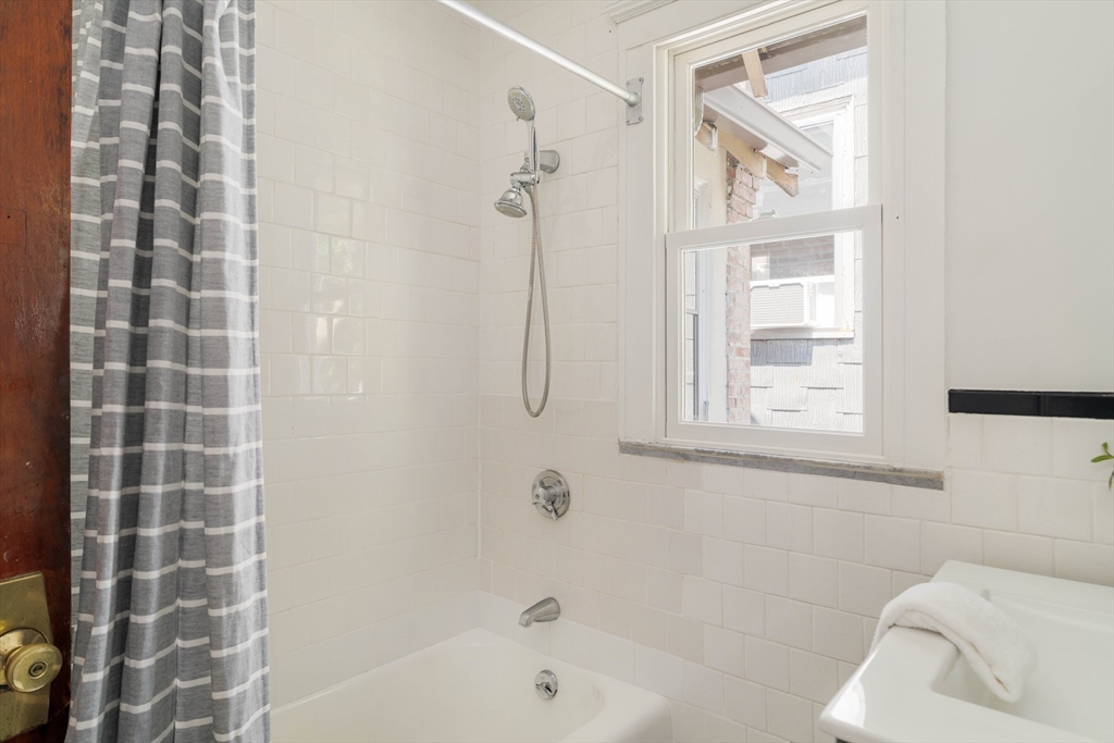 2 Clinton Street, Unit 37 Cambridge, MA 02139 - Photo 21 of 23 a bathroom with a bathtub and shower
