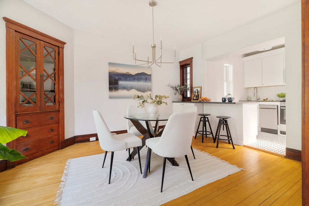 2 Clinton Street, Unit 37 Cambridge, MA 02139 - Photo 6 of 23 a dining room with furniture and wooden floor