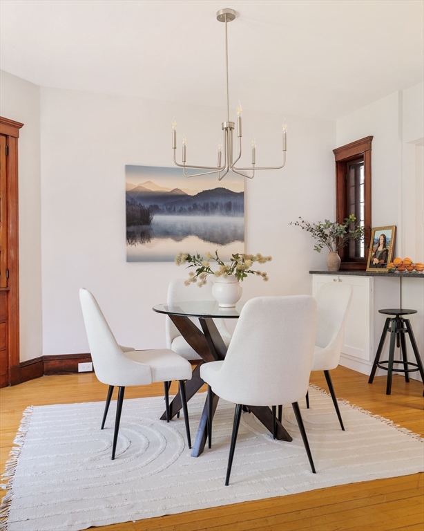 2 Clinton Street, Unit 37 Cambridge, MA 02139 - Photo 7 of 23 a view of a dining room with furniture and wooden floor