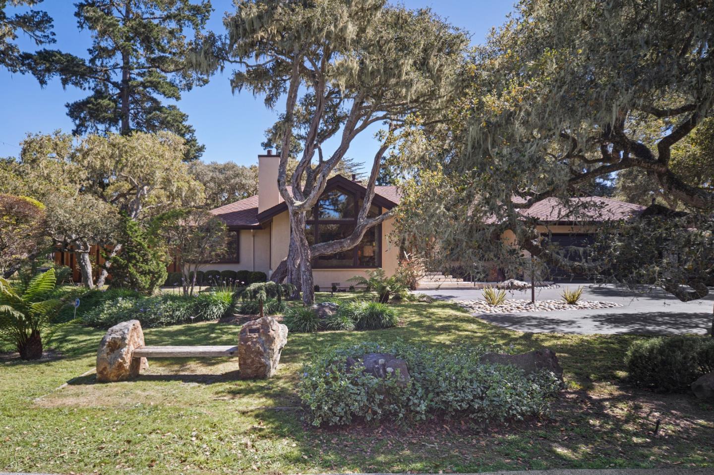 2911 Colton Road Pebble Beach, CA 93953 - Photo 2 of 46 a backyard of a house with table and chairs