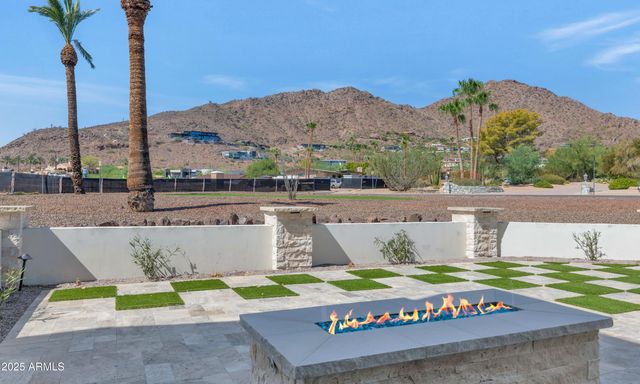 a view of swimming pool with a yard and mountain view