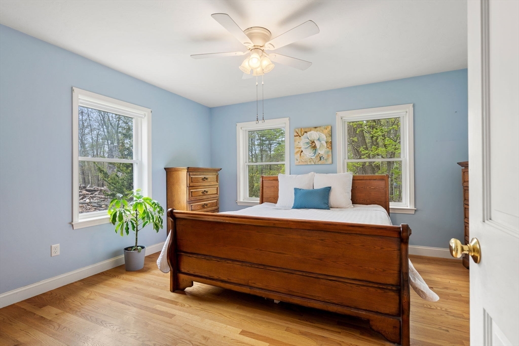 3 Brown Road Townsend, MA 01469 - Photo 17 of 41 a bedroom with a bed and a chandelier