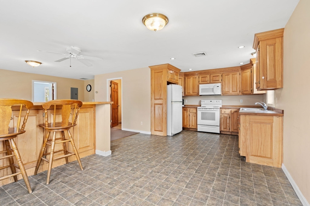 3 Brown Road Townsend, MA 01469 - Photo 29 of 41 a view of kitchen with stainless steel appliances kitchen island granite countertop a refrigerator and a stove top oven