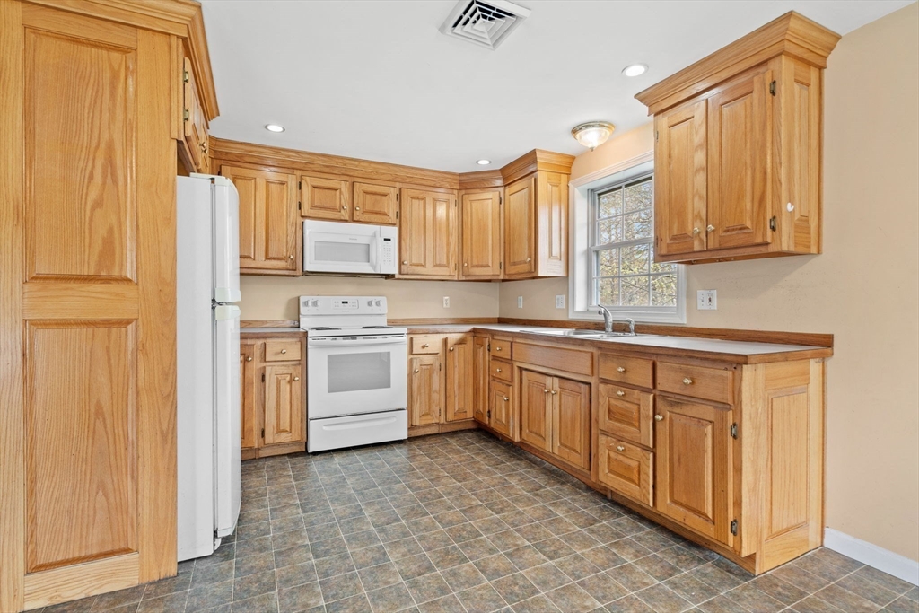 3 Brown Road Townsend, MA 01469 - Photo 30 of 41 a kitchen with white cabinets and white appliances