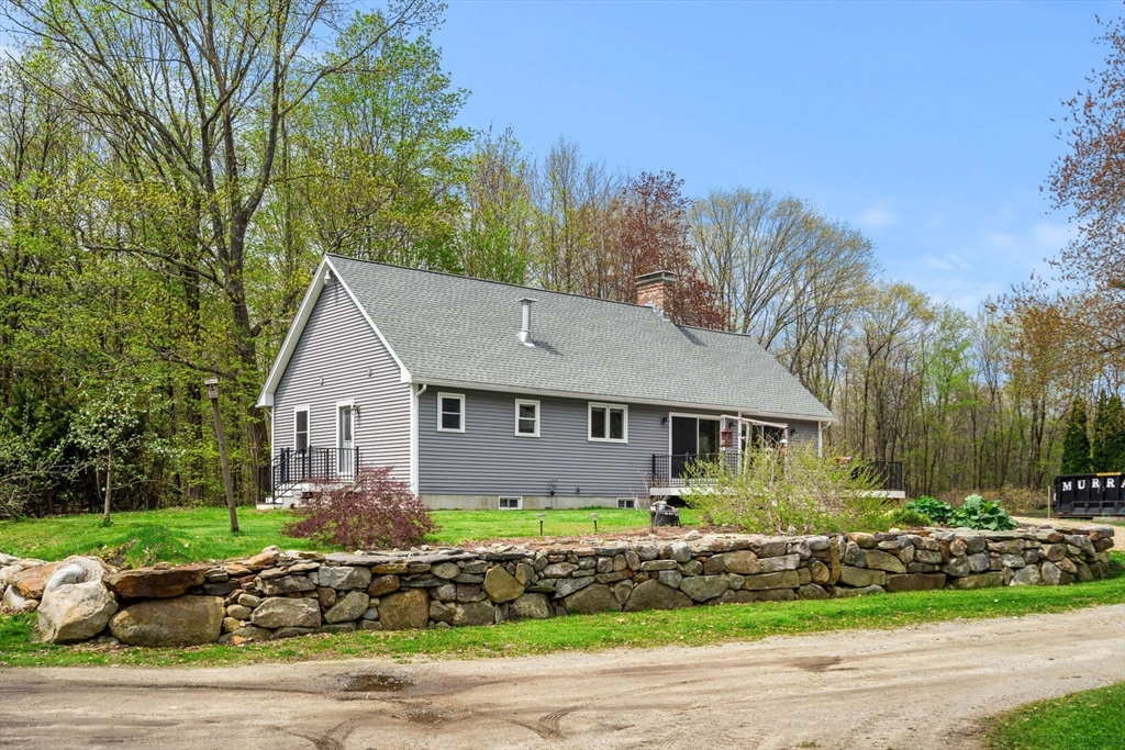 3 Brown Road Townsend, MA 01469 - Photo 9 of 41 a front view of a house with a garden
