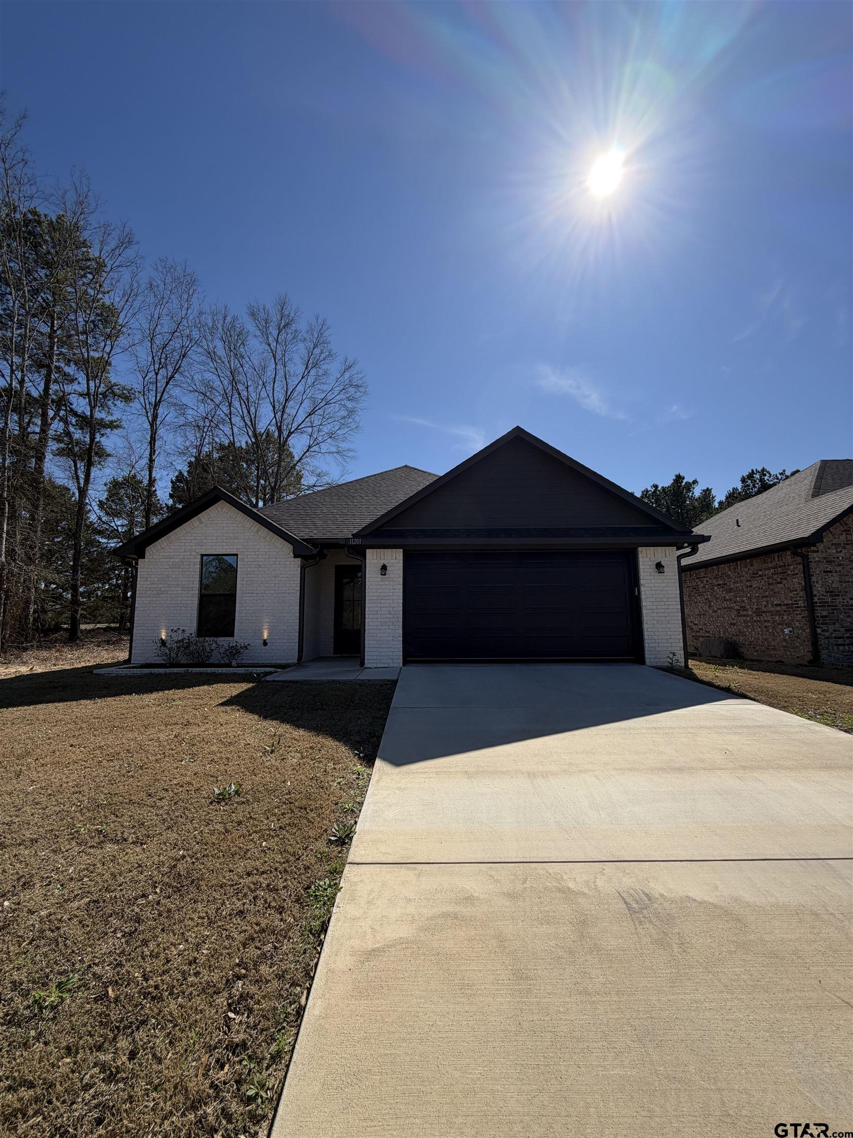 11201 County Road 166 Tyler, TX 75703 - Photo 1 of 19 a front view of a house with a yard and garage