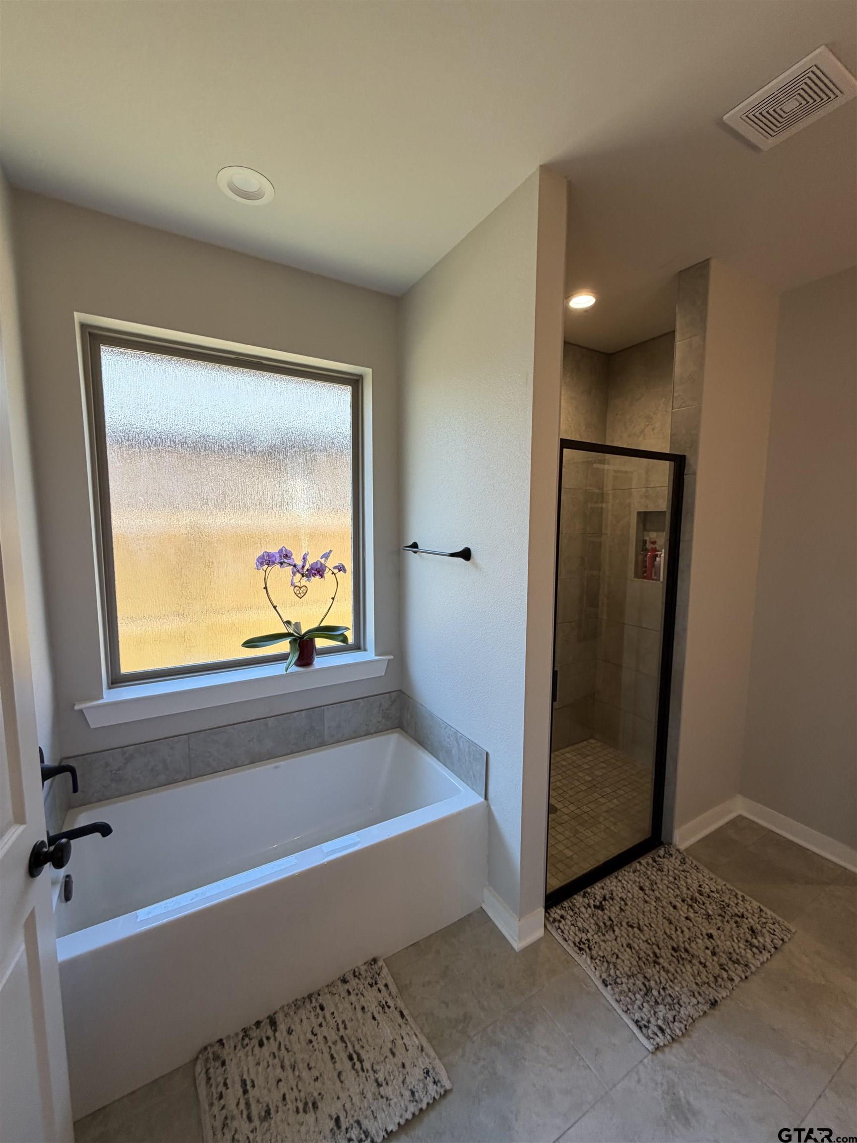 11201 County Road 166 Tyler, TX 75703 - Photo 11 of 19 a bathroom with a tub and a shower