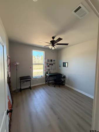 a view of a livingroom with furniture and a window