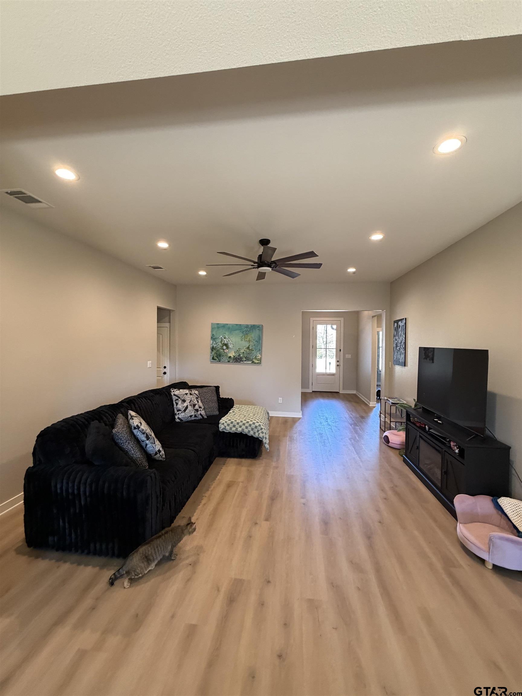 11201 County Road 166 Tyler, TX 75703 - Photo 3 of 19 a living room with furniture and a flat screen tv