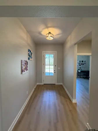 an empty room with wooden floor and a window