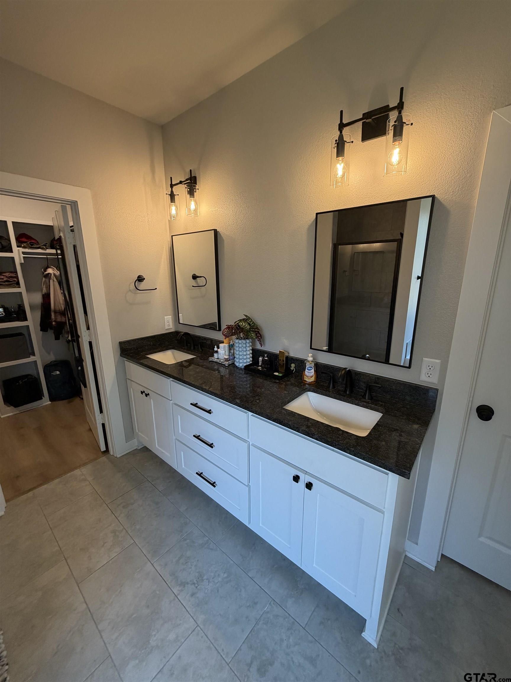 11201 County Road 166 Tyler, TX 75703 - Photo 10 of 19 a spacious bathroom with a double vanity sink and mirror