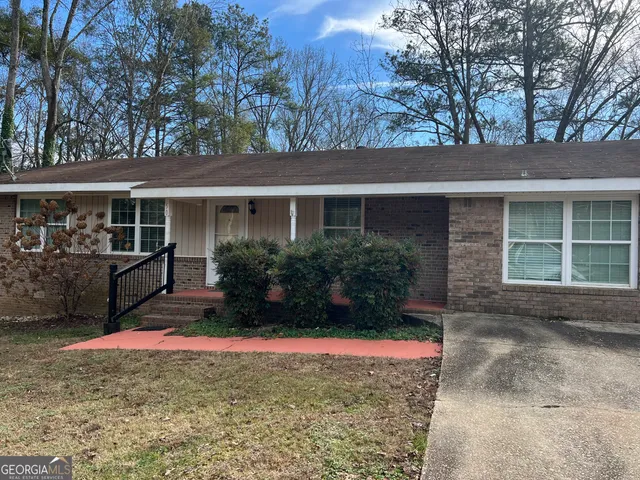 a view of house with outdoor space and garden