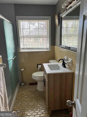 a bathroom with a sink a toilet and a shower