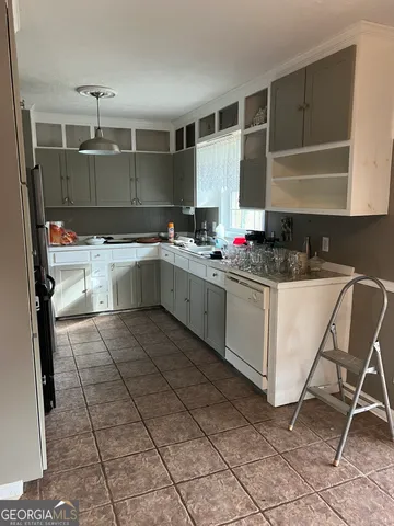 a kitchen with a sink a counter and cabinets
