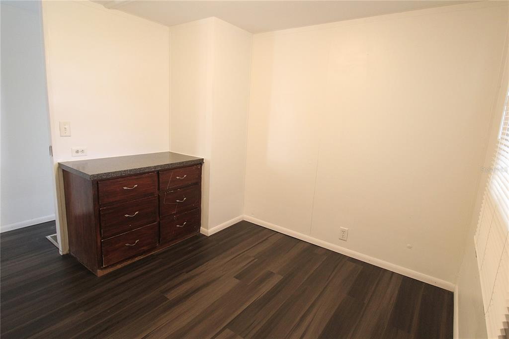503 51st Avenue West, Unit 503 Bradenton, FL 34207 - Photo 16 of 19 a room with a dresser