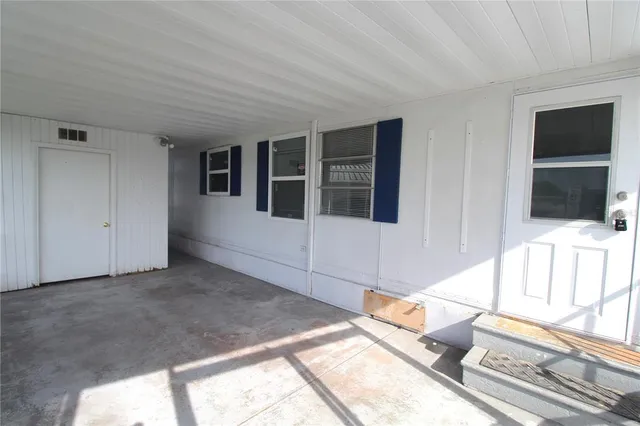 a living room with a large window and a flat screen tv