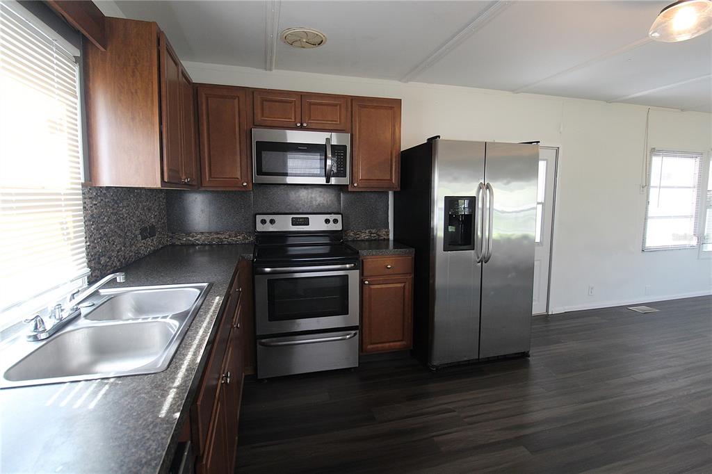 503 51st Avenue West, Unit 503 Bradenton, FL 34207 - Photo 4 of 19 a kitchen with a refrigerator sink and microwave