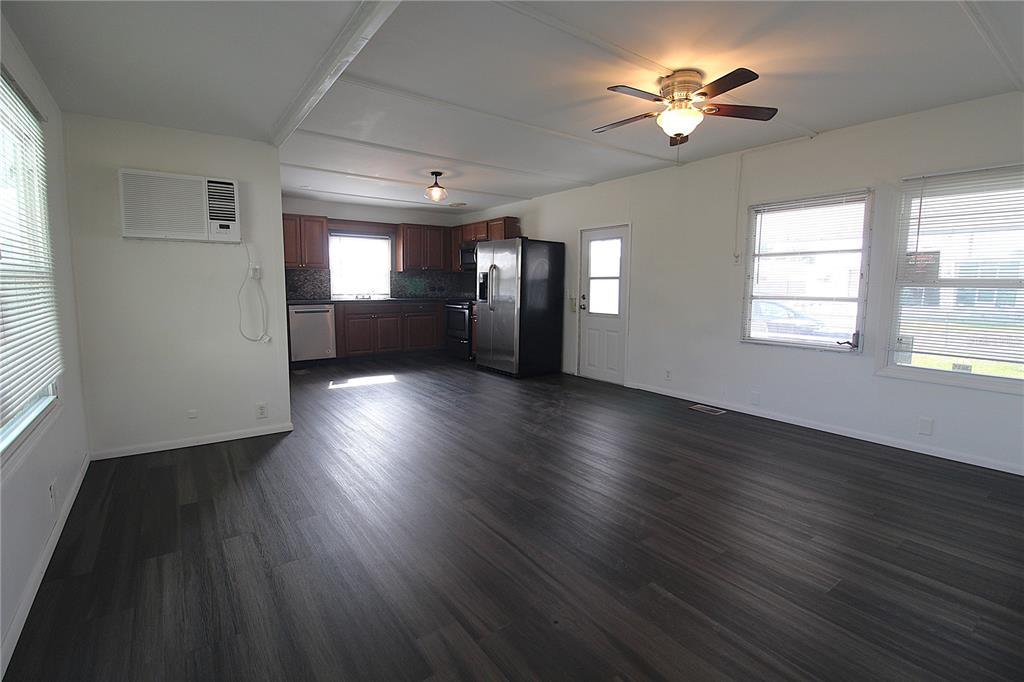 503 51st Avenue West, Unit 503 Bradenton, FL 34207 - Photo 7 of 19 a view of an empty room with a window and wooden floor