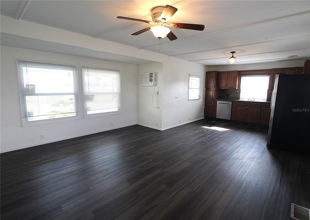 503 51st Avenue West, Unit 503 Bradenton, FL 34207 - Photo 8 of 19 a view of an empty room with wooden floor and a window