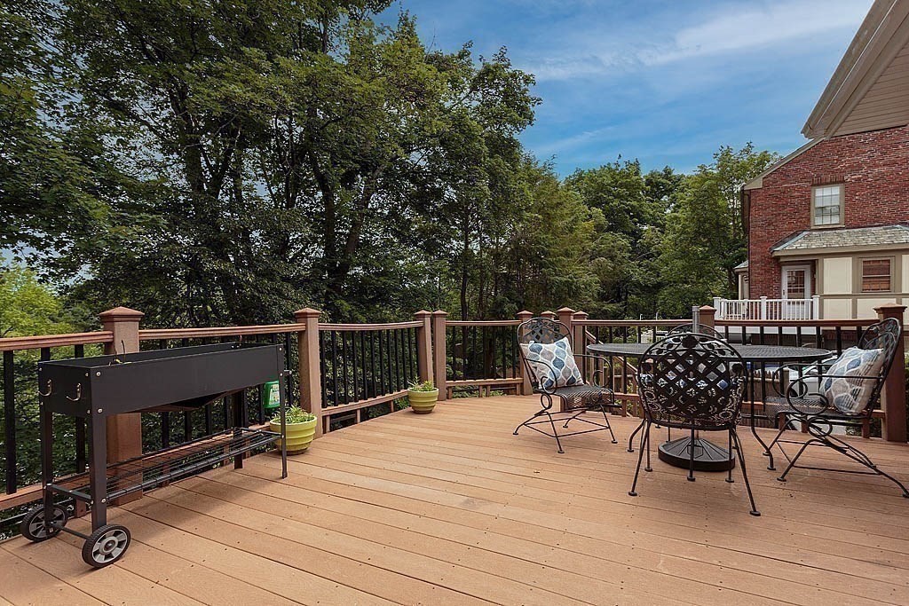 41 Goodnough Road Brookline, MA 02467 - Photo 35 of 36 a view of a roof deck with table and chairs a barbeque with wooden floor and fence