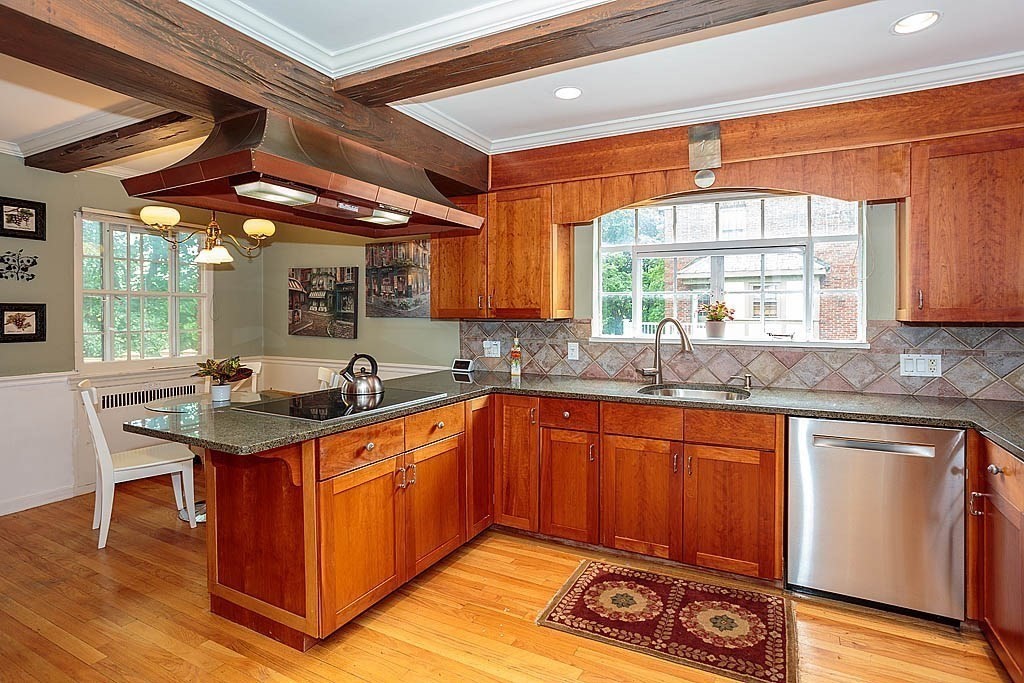41 Goodnough Road Brookline, MA 02467 - Photo 8 of 36 a kitchen with stainless steel appliances granite countertop a sink a stove and wooden cabinets