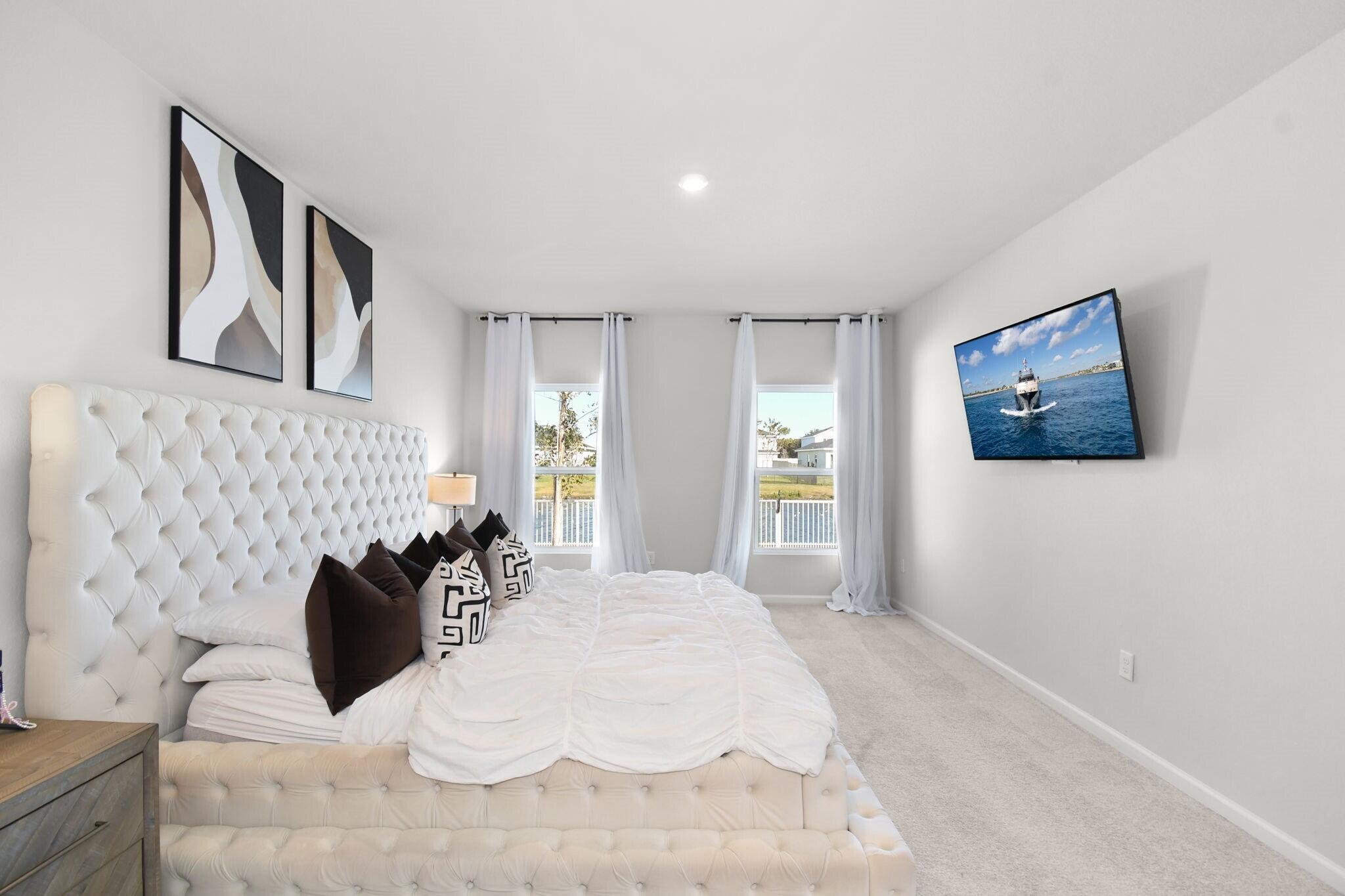 113 Dabou Loop Belle Glade, FL 33430 - Photo 11 of 22 a bedroom with a bed and painting on the wall