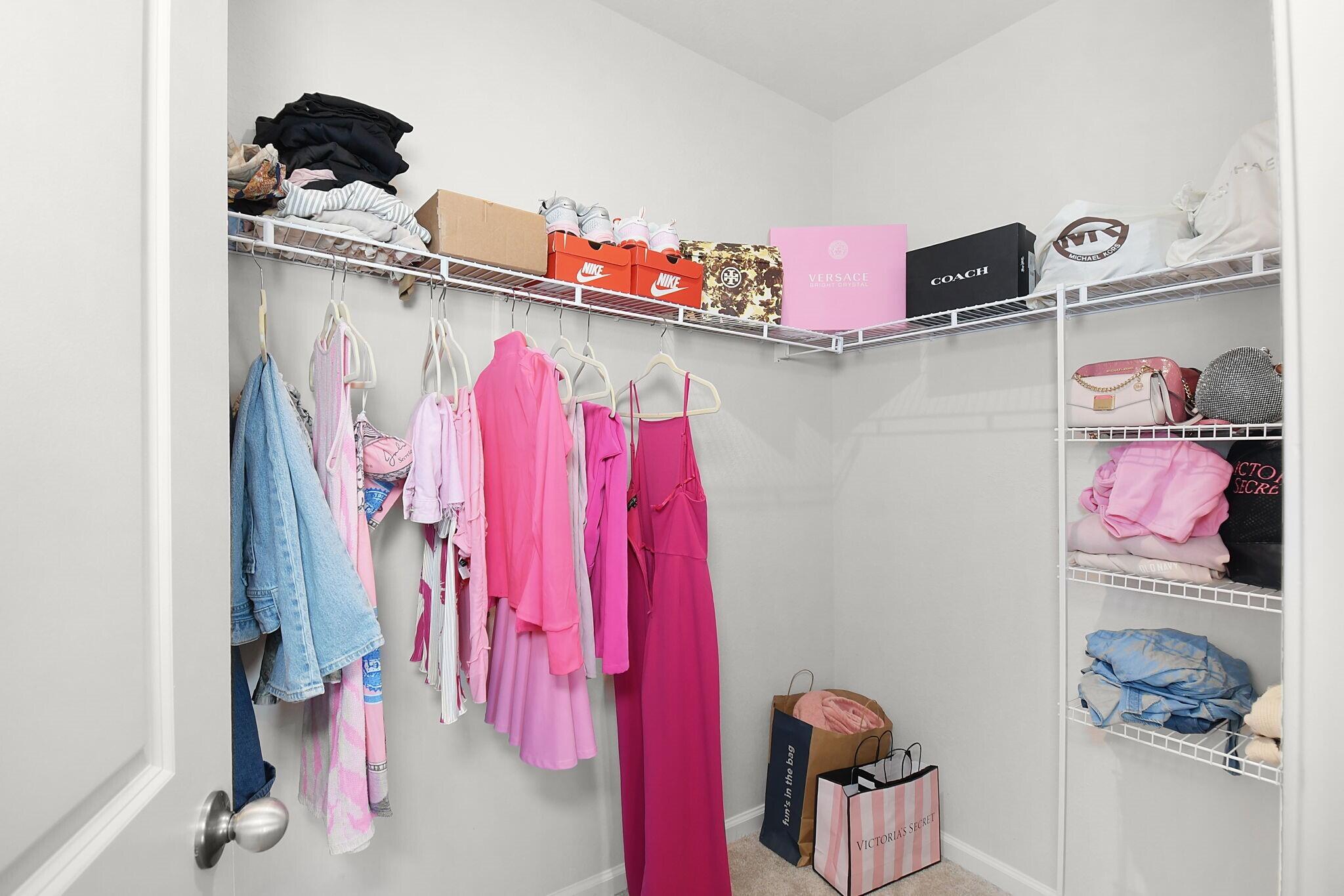 113 Dabou Loop Belle Glade, FL 33430 - Photo 12 of 22 a view of walk in closet with clothes and shoes