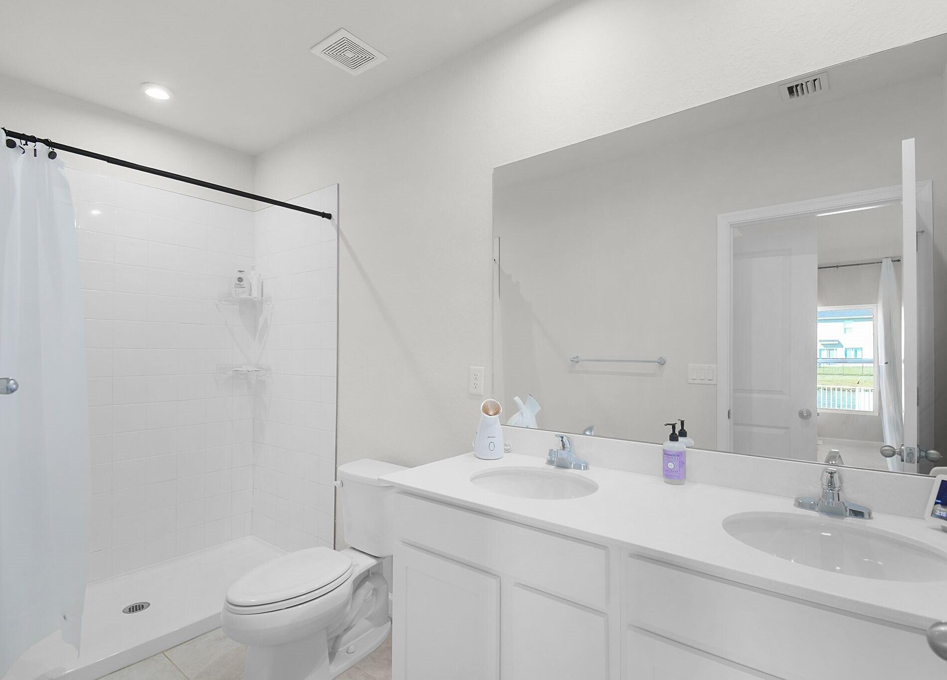 113 Dabou Loop Belle Glade, FL 33430 - Photo 13 of 22 a bathroom with a sink toilet and shower