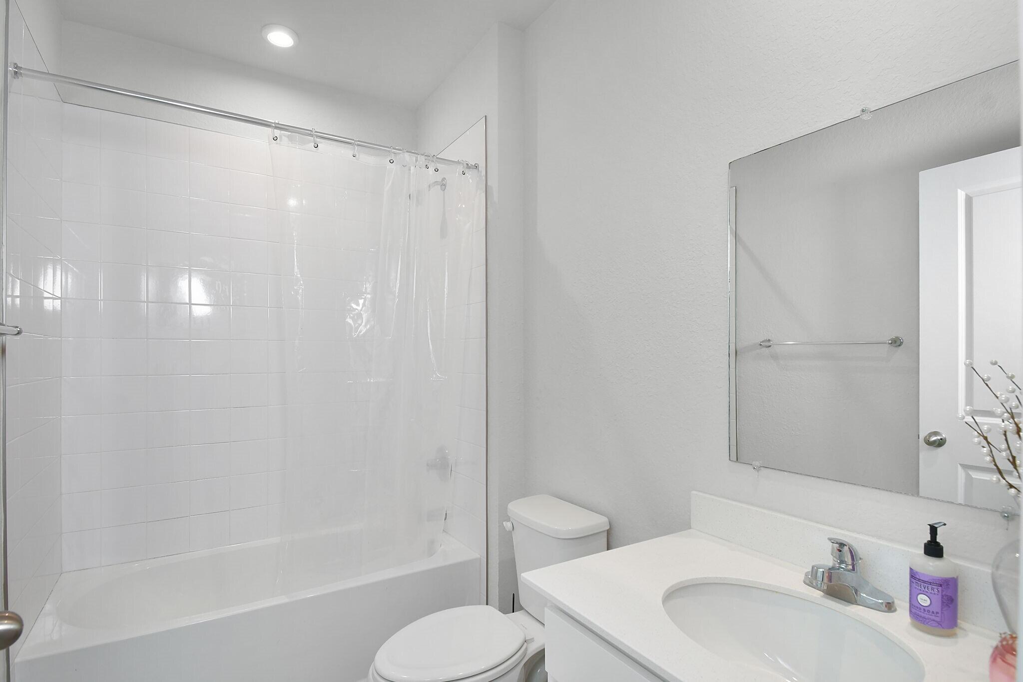 113 Dabou Loop Belle Glade, FL 33430 - Photo 17 of 22 a bathroom with a sink toilet and shower