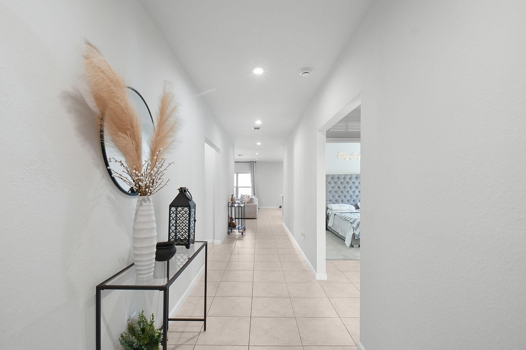 113 Dabou Loop Belle Glade, FL 33430 - Photo 19 of 22 a very nice looking room with a mirror