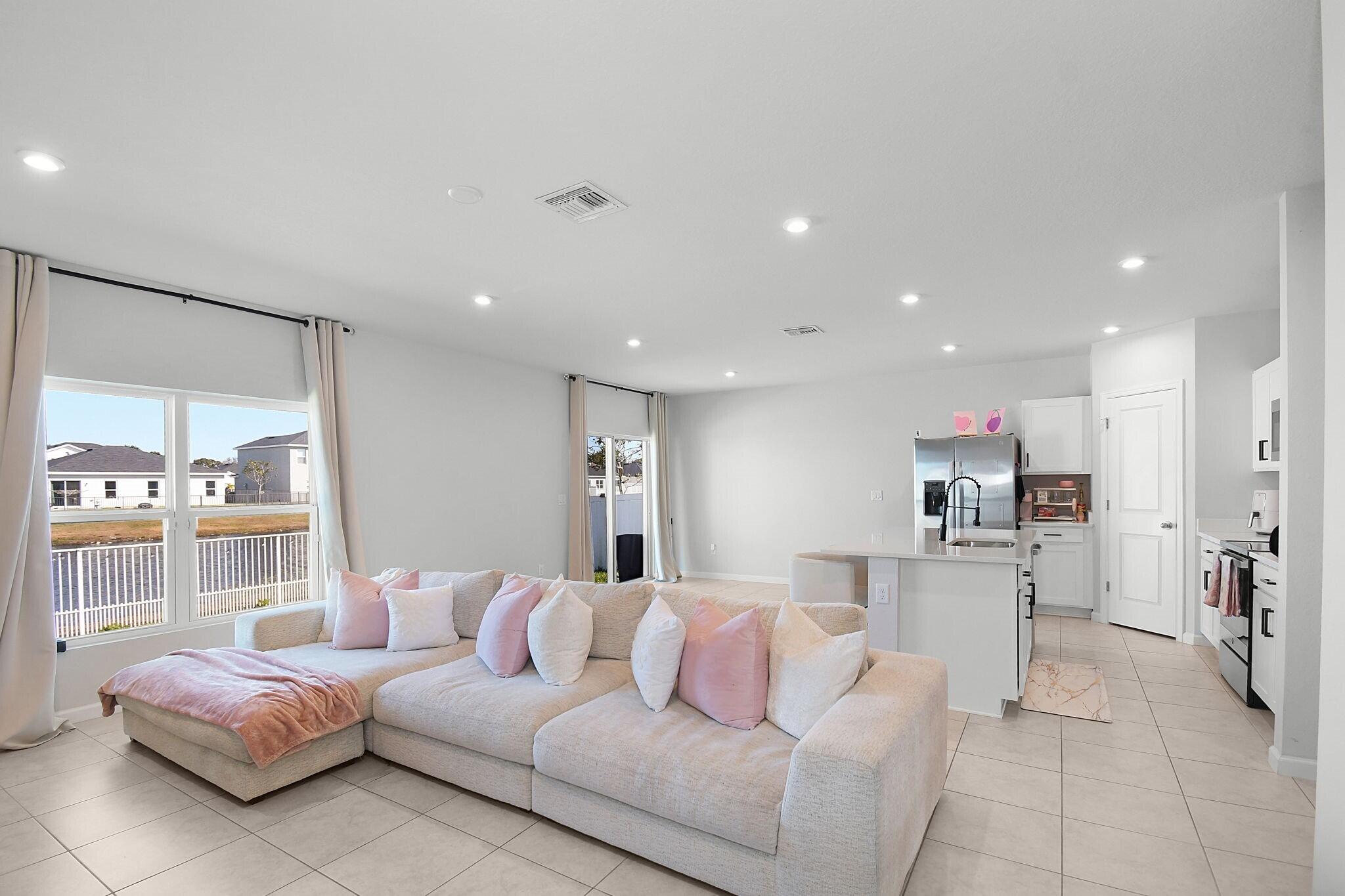 113 Dabou Loop Belle Glade, FL 33430 - Photo 5 of 22 a living room with furniture and a large window