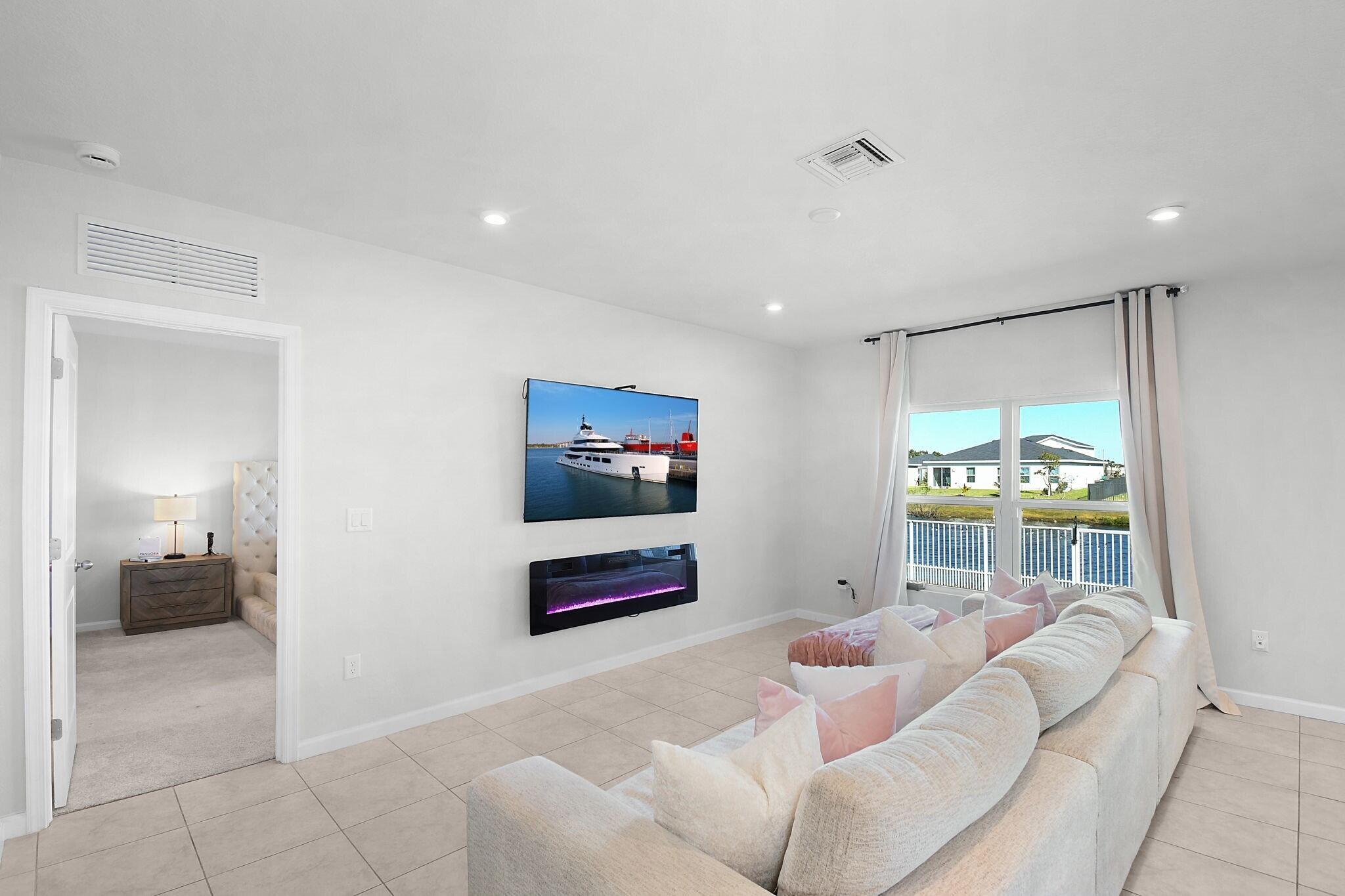 113 Dabou Loop Belle Glade, FL 33430 - Photo 6 of 22 a living room with furniture and a flat screen tv