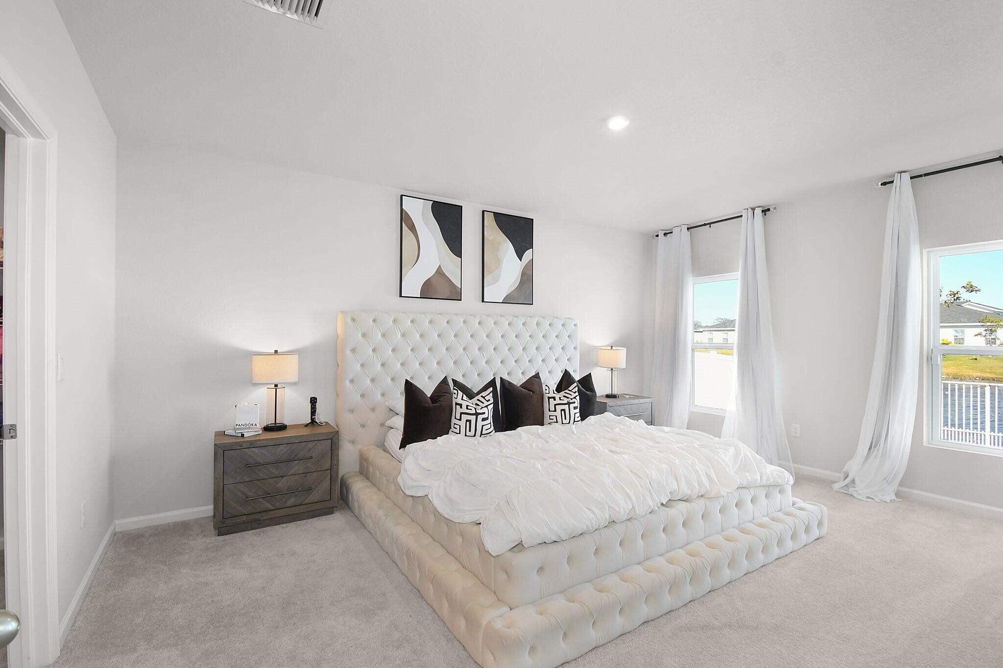 113 Dabou Loop Belle Glade, FL 33430 - Photo 10 of 22 a bedroom with a bed and a lamp