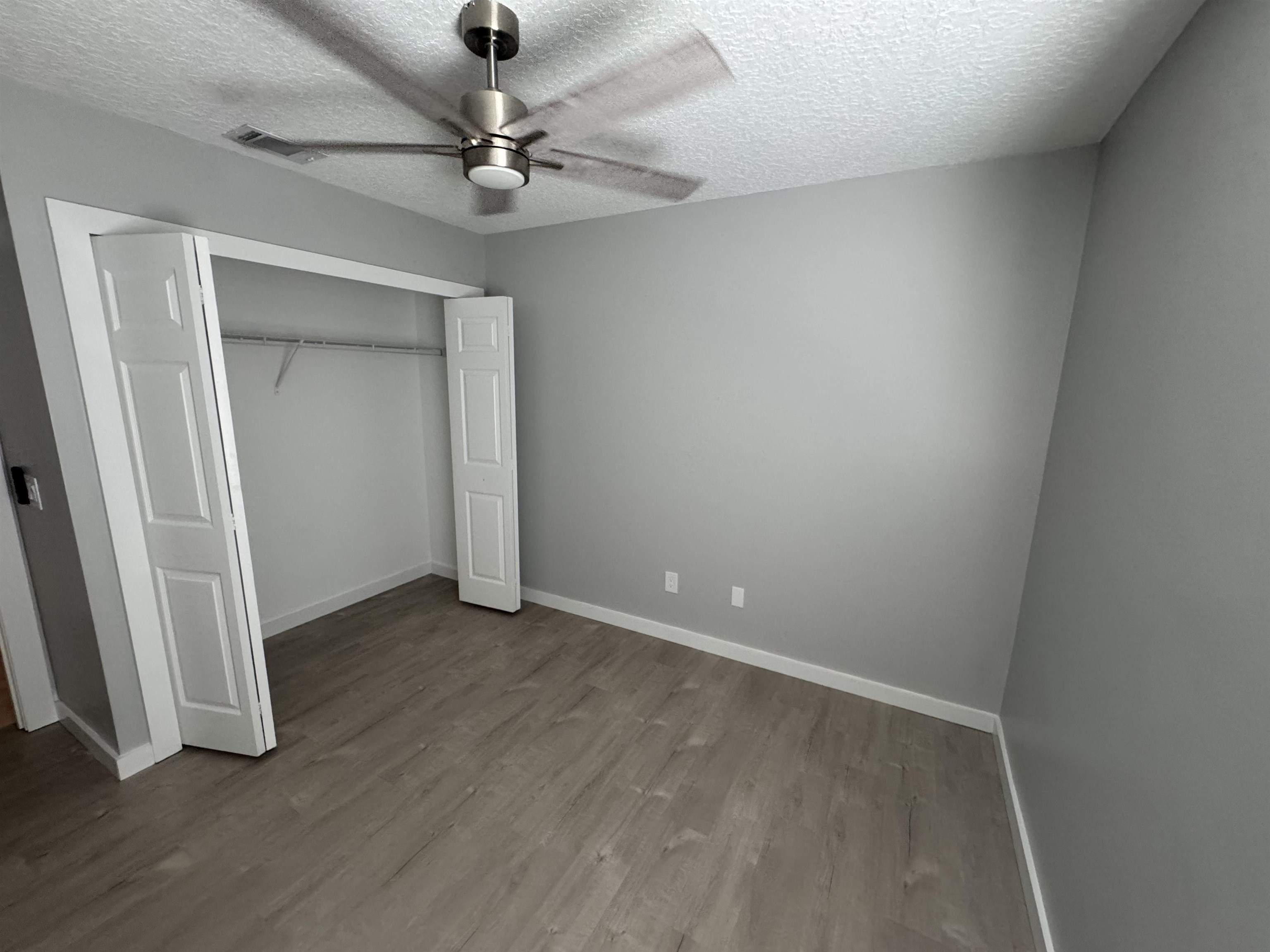 3372 9th Street Elkton, FL 32033 - Photo 12 of 17 an empty room with a fan and a ceiling fan