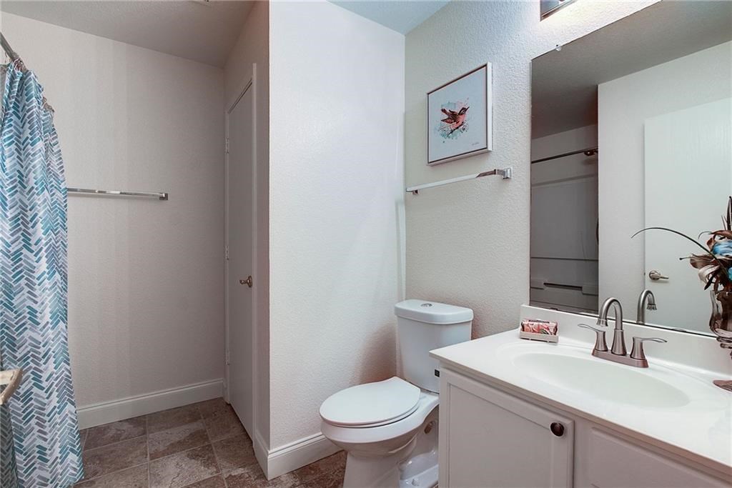 7107 Alegre Pass Austin, TX 78744 - Photo 15 of 20 a bathroom with a toilet sink and a mirror