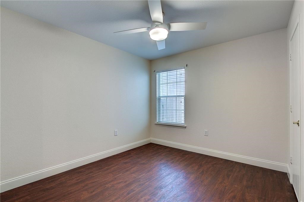 7107 Alegre Pass Austin, TX 78744 - Photo 16 of 20 an empty room with wooden floor and windows