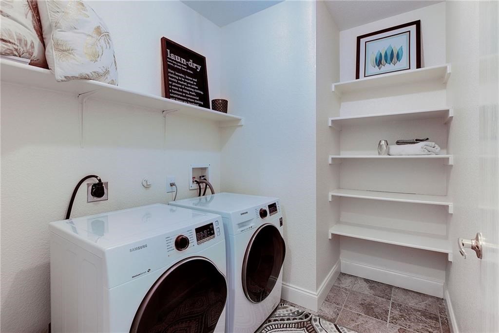 7107 Alegre Pass Austin, TX 78744 - Photo 17 of 20 a utility room with dryer and washer