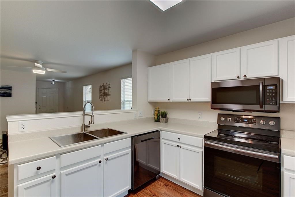 7107 Alegre Pass Austin, TX 78744 - Photo 8 of 20 a kitchen with a sink stove and microwave