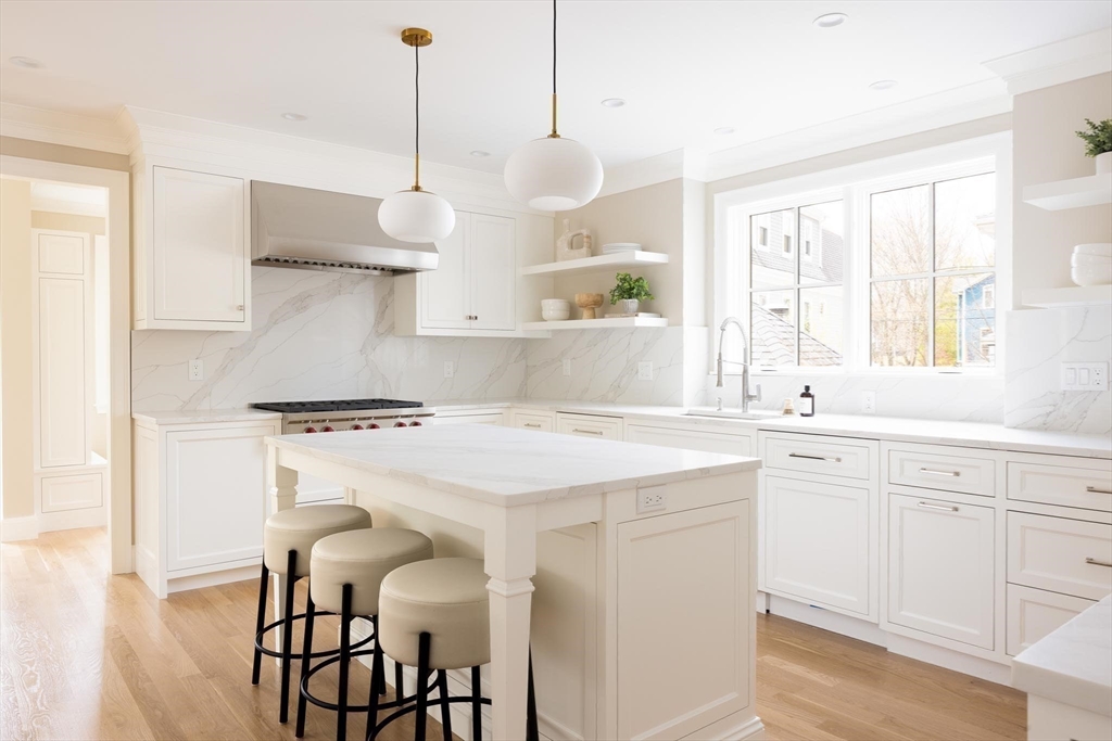15 Woodcliff Road Newton, MA 02461 - Photo 11 of 27 a kitchen with a stove a sink and cabinets