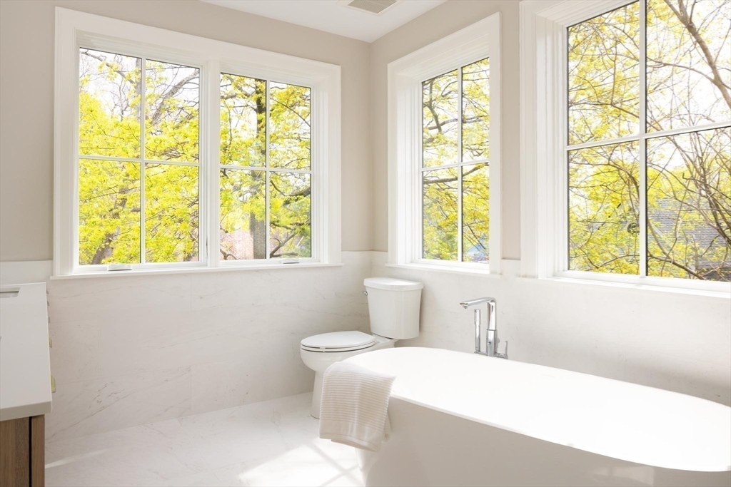 15 Woodcliff Road Newton, MA 02461 - Photo 16 of 27 a bathroom with a bathtub and window