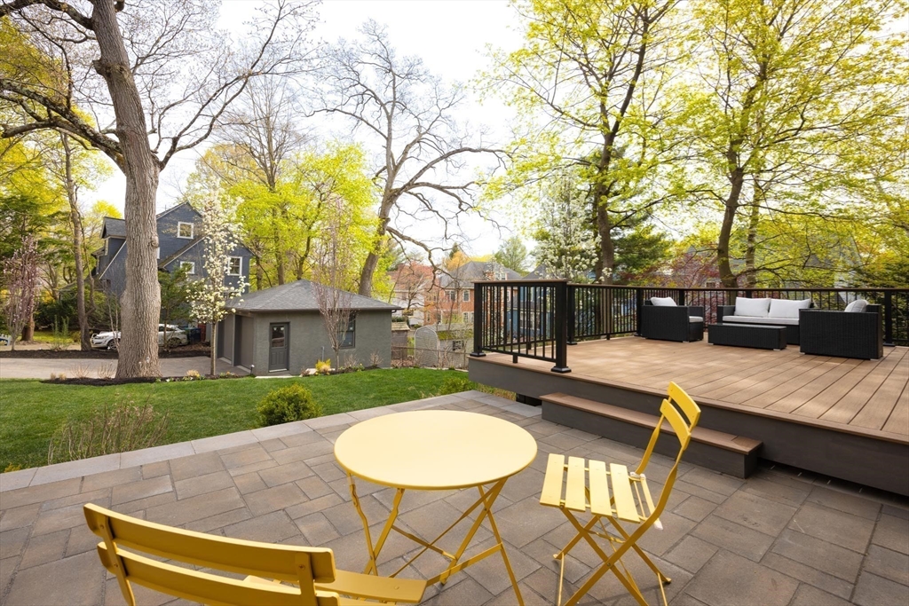 15 Woodcliff Road Newton, MA 02461 - Photo 23 of 27 a view of a patio with a table chairs and a fire pit
